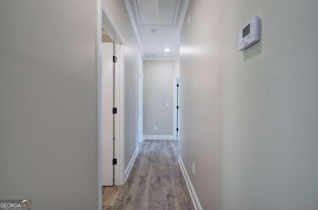 hallway with hardwood / wood-style flooring and crown molding