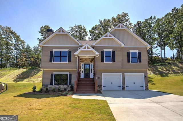 view of front of home with a garage and a front lawn