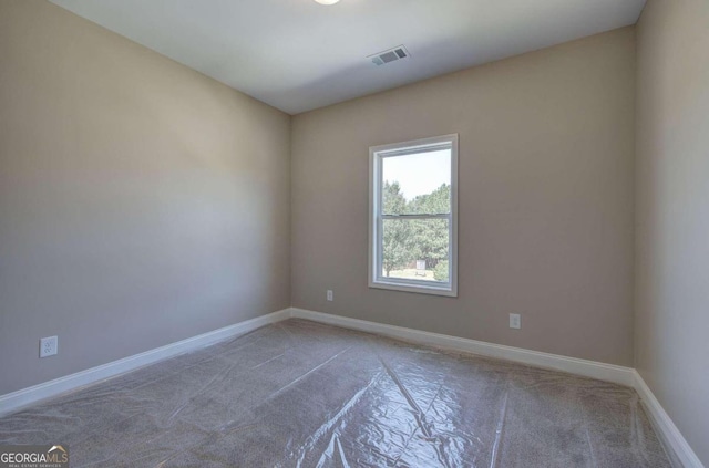 empty room featuring visible vents and baseboards