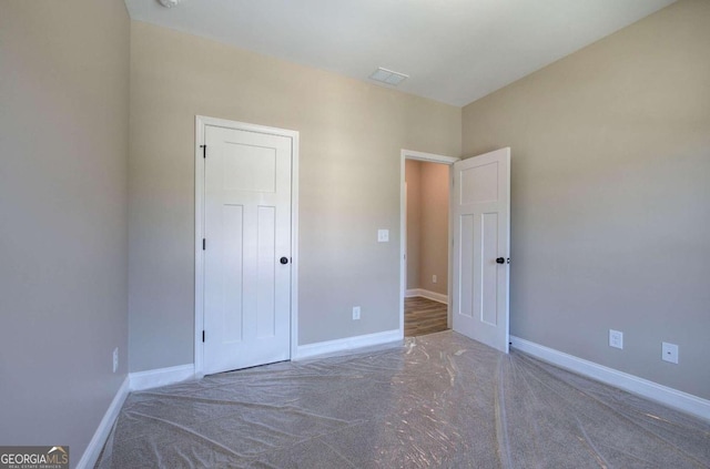 unfurnished bedroom featuring visible vents and baseboards