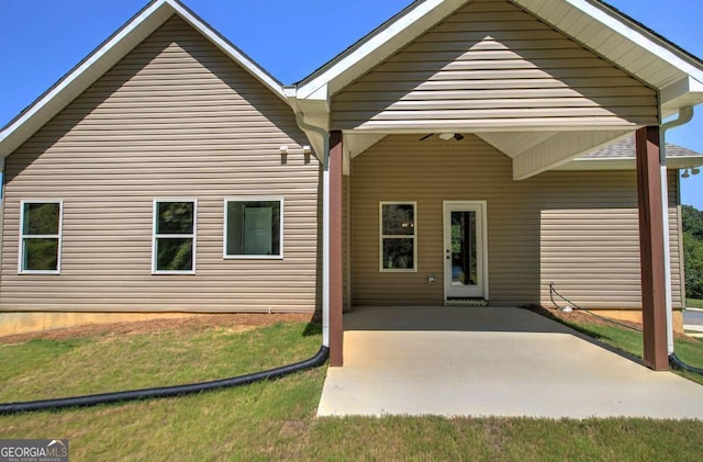 exterior space featuring ceiling fan, a lawn, and a patio area