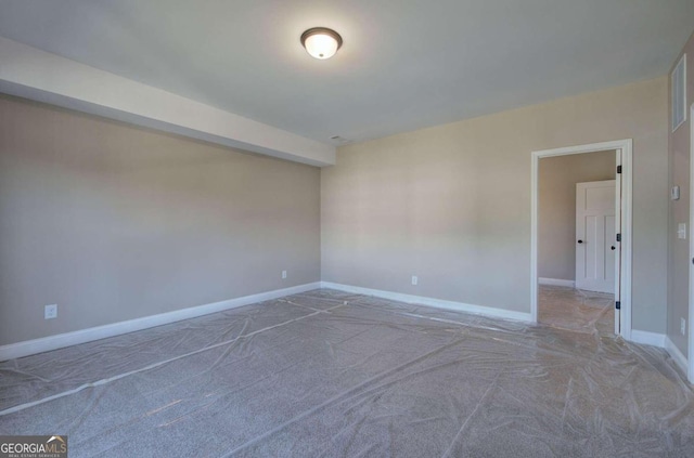 unfurnished room featuring carpet flooring and baseboards