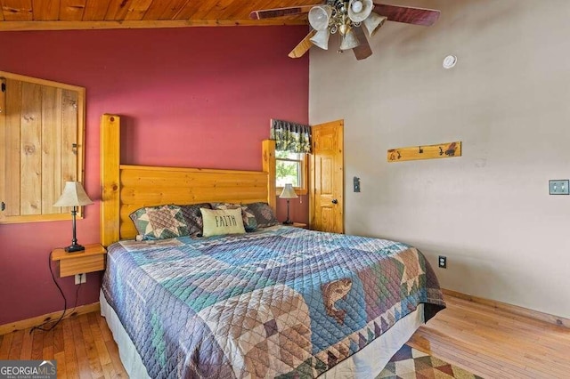 bedroom featuring wooden ceiling, high vaulted ceiling, wood-type flooring, and ceiling fan