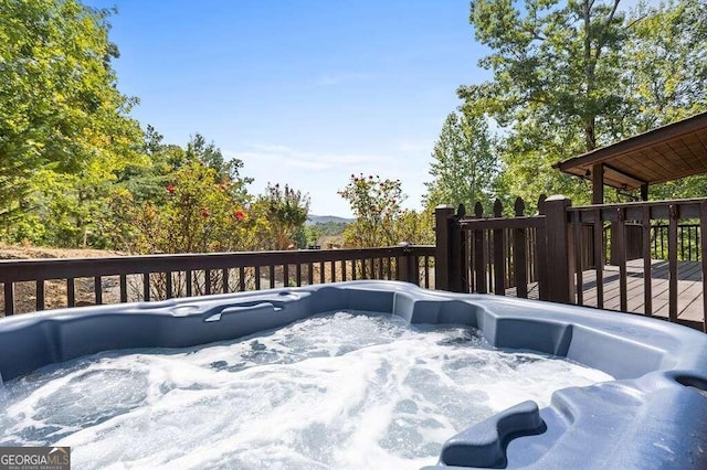 wooden deck with a hot tub