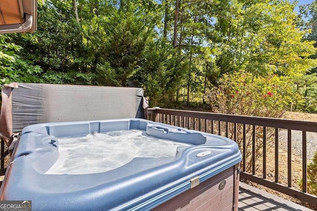 wooden deck featuring a hot tub