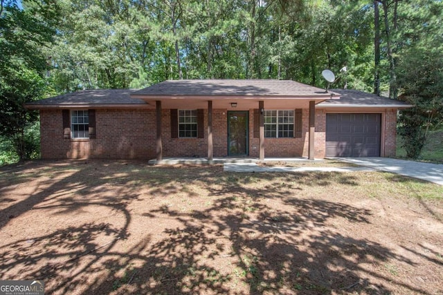 single story home featuring a porch and a garage