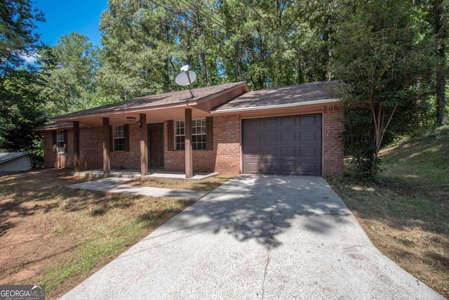 ranch-style house featuring a front yard, a porch, and a garage