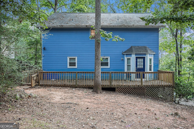 rear view of property featuring a deck