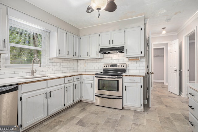 kitchen with white cabinetry, stainless steel appliances, sink, and ceiling fan