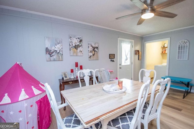 dining space with light wood-type flooring, crown molding, and ceiling fan