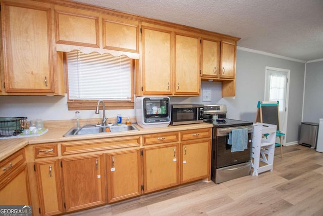 kitchen featuring a textured ceiling, appliances with stainless steel finishes, crown molding, sink, and light wood-type flooring