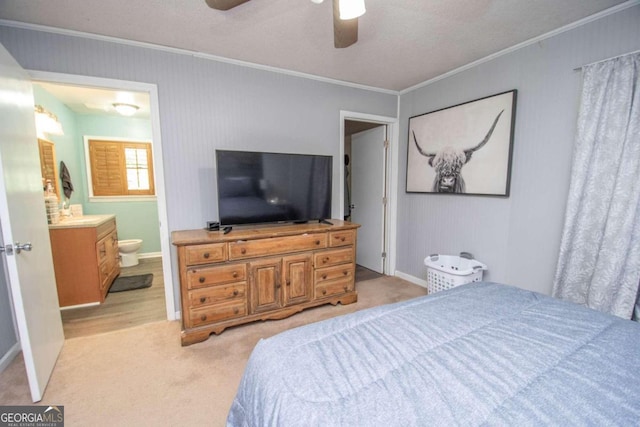 bedroom featuring ceiling fan, connected bathroom, light carpet, and ornamental molding