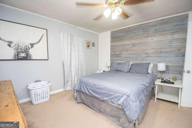 carpeted bedroom with a textured ceiling, crown molding, and ceiling fan