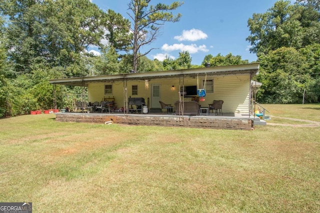 rear view of property with a lawn and a patio area