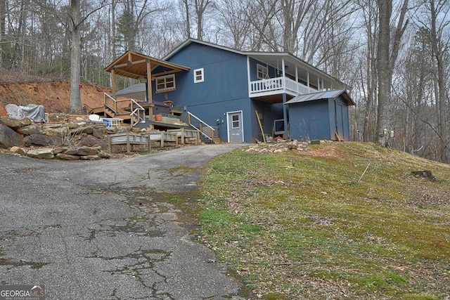 back of property featuring a balcony