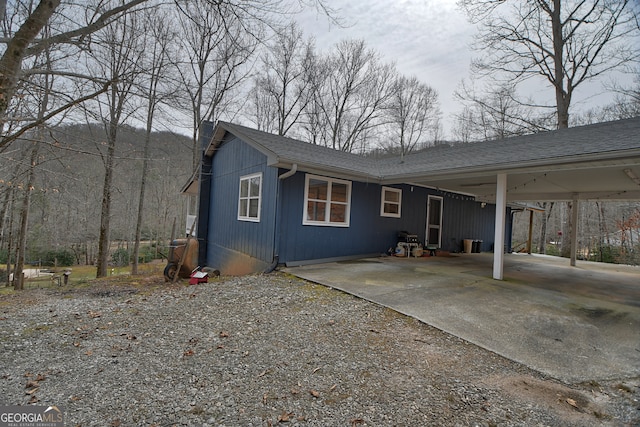 view of side of property with a carport