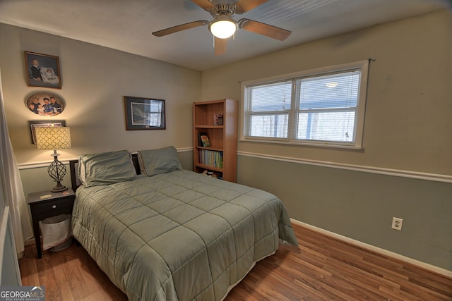 bedroom with ceiling fan and hardwood / wood-style flooring