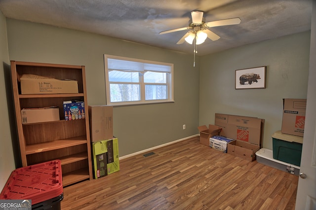 recreation room featuring ceiling fan and hardwood / wood-style floors