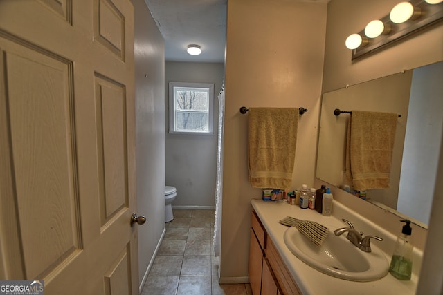 bathroom with tile patterned flooring, toilet, and vanity