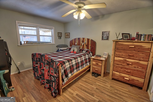 bedroom featuring ceiling fan and hardwood / wood-style flooring