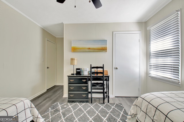 bedroom featuring ceiling fan, ornamental molding, wooden walls, and hardwood / wood-style floors