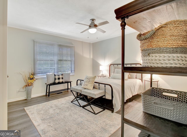 bedroom featuring ceiling fan and wood-type flooring