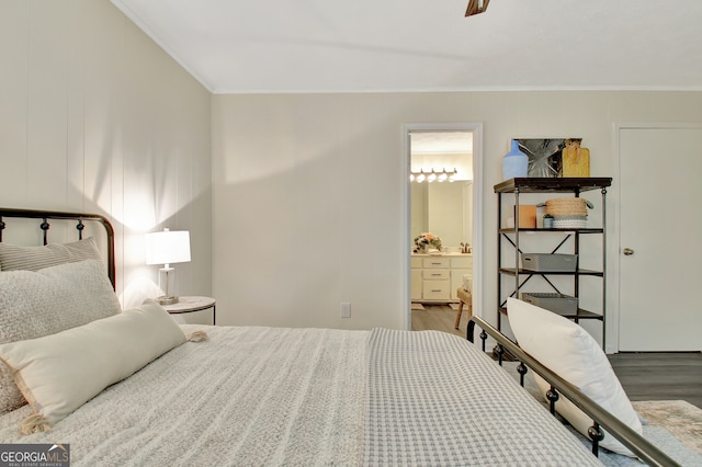 bedroom featuring ornamental molding, ensuite bathroom, dark hardwood / wood-style floors, and ceiling fan