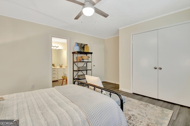 bedroom featuring ensuite bath, a closet, ceiling fan, crown molding, and dark hardwood / wood-style floors