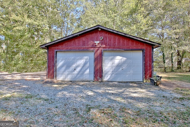 garage featuring wood walls