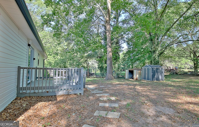 view of yard with a shed and a wooden deck