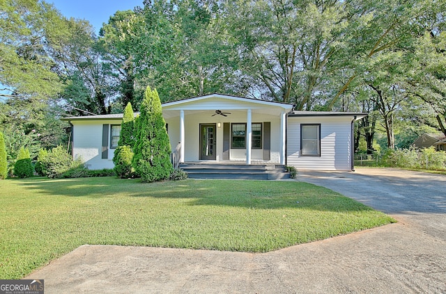 ranch-style home featuring covered porch, a front lawn, and ceiling fan