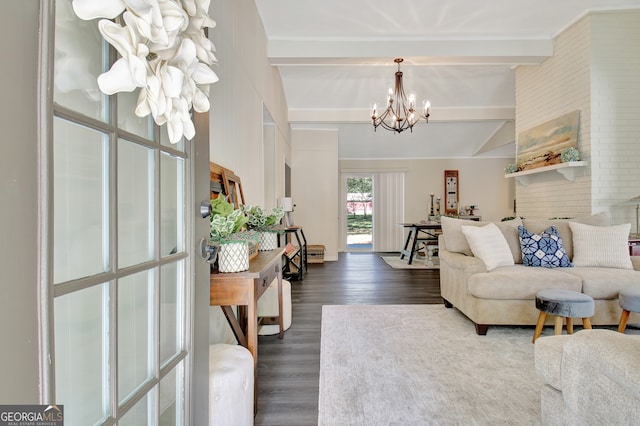 living room featuring beamed ceiling, a notable chandelier, dark hardwood / wood-style floors, and brick wall