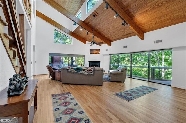 living room with high vaulted ceiling, ceiling fan, and a healthy amount of sunlight