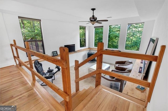 interior space with ceiling fan and hardwood / wood-style flooring