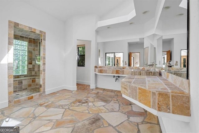 bathroom featuring a wealth of natural light and separate shower and tub