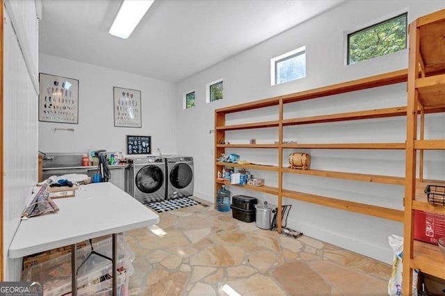 clothes washing area with separate washer and dryer