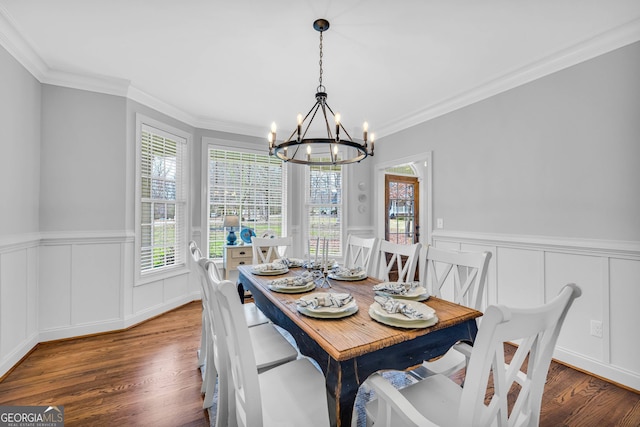 dining area featuring ornamental molding, dark hardwood / wood-style floors, and a chandelier