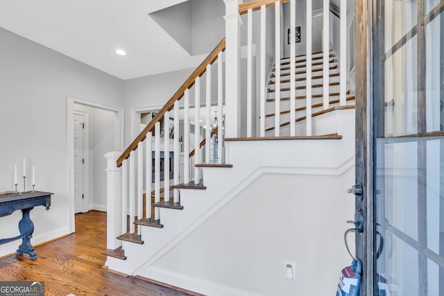 staircase with hardwood / wood-style floors