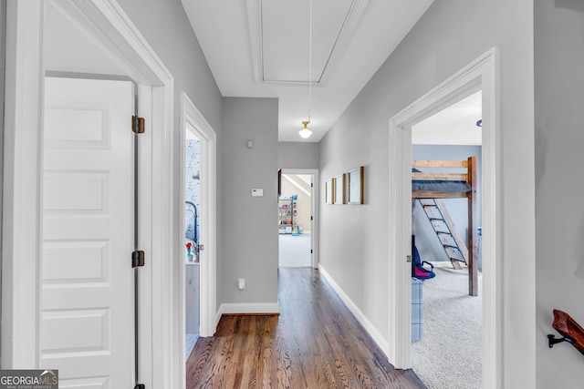 hall with dark colored carpet