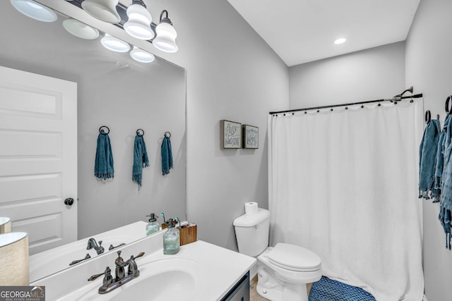 bathroom featuring vanity, toilet, curtained shower, and a chandelier