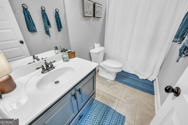 bathroom with vanity, toilet, and tile patterned flooring