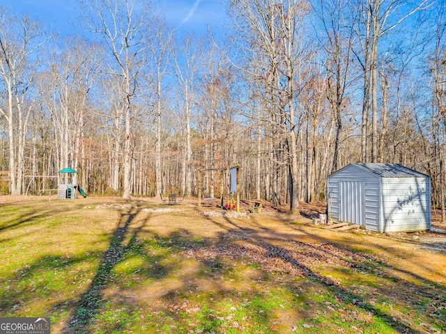 view of yard with a playground and a storage unit