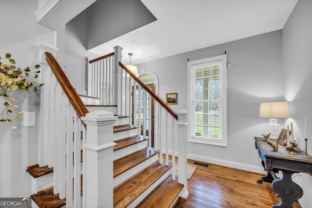 stairs featuring hardwood / wood-style floors