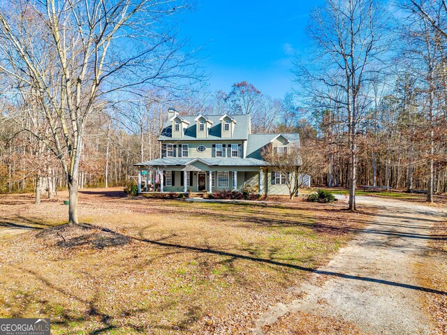 cape cod house featuring a porch