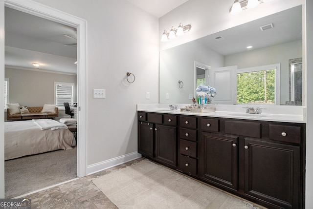 ensuite bathroom with baseboards, visible vents, a sink, and ensuite bathroom