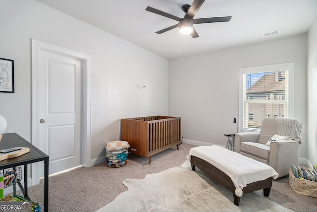 carpeted bedroom with a ceiling fan, visible vents, and baseboards