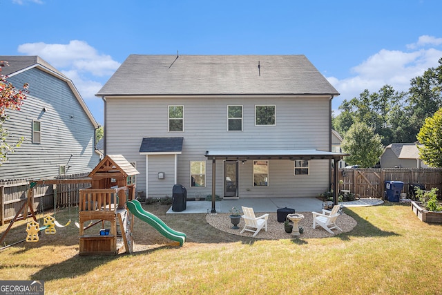 rear view of property with a playground, a yard, a patio area, and a fenced backyard