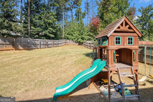 view of play area with a yard and a fenced backyard