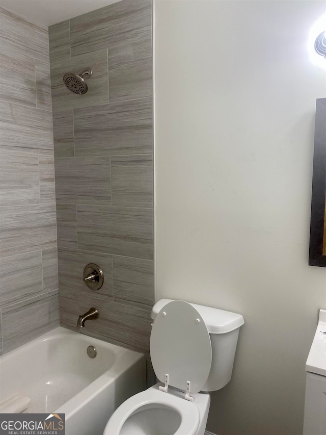 full bathroom featuring vanity, toilet, and tiled shower / bath