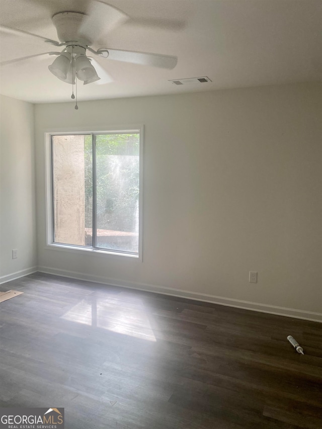 empty room with ceiling fan and dark hardwood / wood-style floors